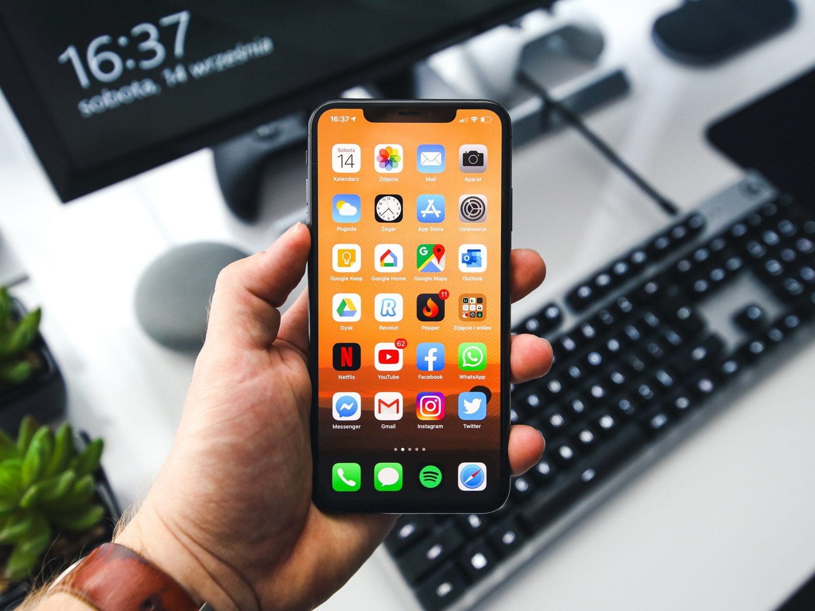 iphone-with-hand-scaled iOS 15 updates and the impact on Fliplet apps and app creators